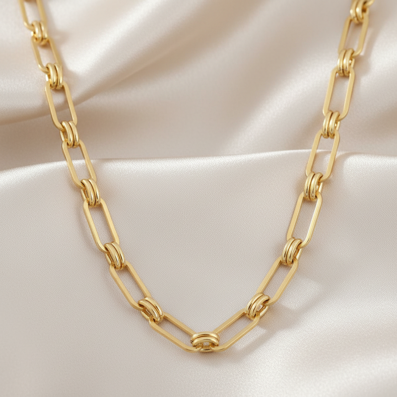 Stainless steel, 18K gold PVD chunky chain necklace on a beige fabric background
